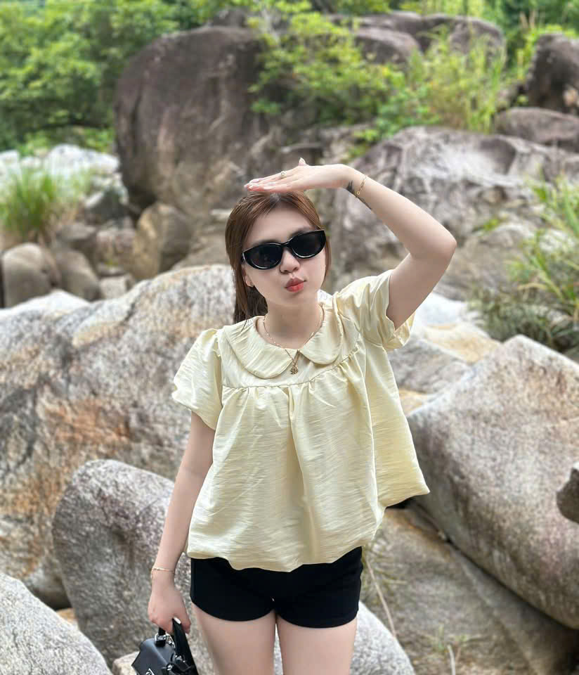 Yellow Top Girl by the River Rocks — © SIGIL