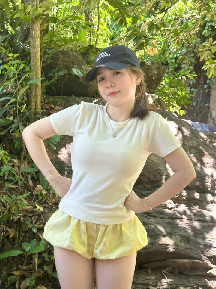 Girl in Cap and Yellow Shorts in Forest — © SIGIL