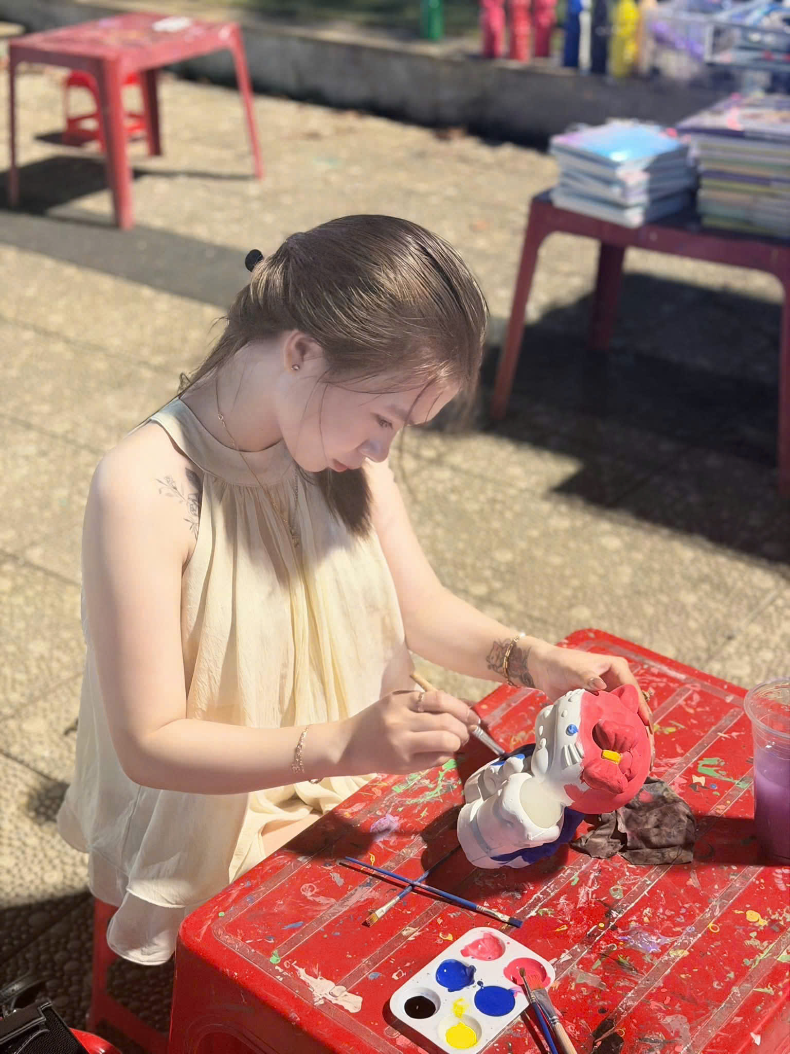 Girl Painting Statue Outdoors — © SIGIL