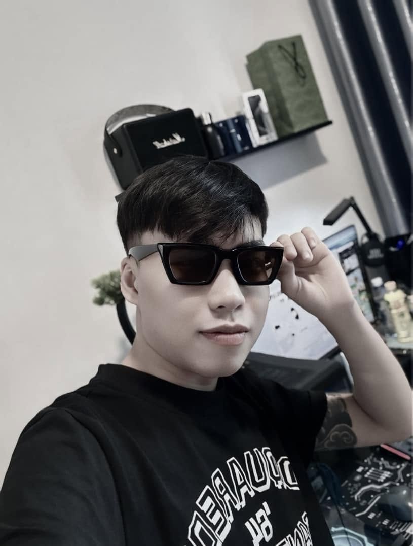 Self-Portrait of a Young Man Adjusting His Black Sunglasses at His Work — © SIGIL